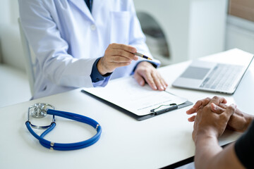 Close up view of professional physician consulting with male patient, talking to male client at medical checkup visit