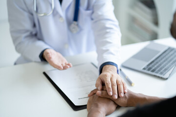 Close up view of friendly doctor hold patient hand in office during the visiting. giving hope and empathy.