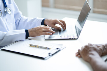 Close up view of professional physician consulting with male patient, talking to male client at medical checkup visit