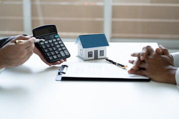 Close up view of real estate showing the calculated price of the house to client.