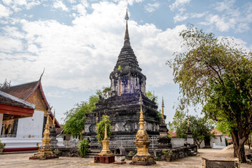 Fototapeta premium Ancient stupa at Wat Hosian Voravihane Buddhist Temple in Luang Prabang Laos
