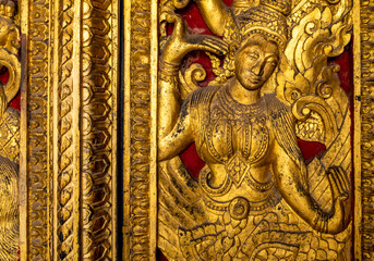 Golden fresco at Wat Hosian Voravihane Buddhist Temple in Luang Prabang Laos