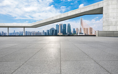 Empty square floor and wall with city skyline scenery