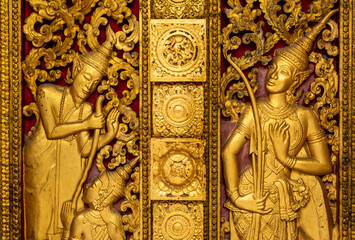 Fototapeta na wymiar Golden fresco at Wat Hosian Voravihane Buddhist Temple in Luang Prabang Laos