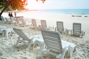 Beach bed ,white plastic beds or trampoline bench with in sea beach tropical for tourists to rest on summer holiday with bright blue sky background.