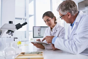 Papier Peint photo Lavable Pharmacie Scientist, tablet and team in forensic science looking at experiment results or collaboration at laboratory. Woman and man in medical research working on technology for scientific research in the lab