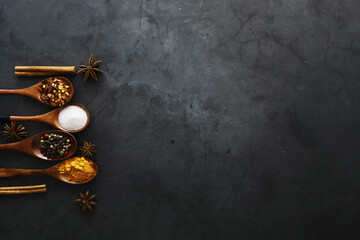 Wooden spoons with spices. A mixture of peppers and spices. Fragrant herbs for food.