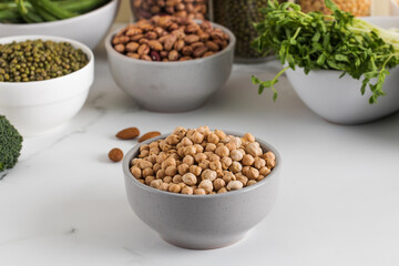 Raw chickpeas in a bowl on a light background. Vegetable protein. Vegetarianism.