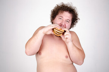 Diet and healthy lifestyle. Funny fat man eating a burger.	