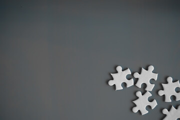 Clean puzzle elements on the red background. Empty puzzle piece on the table. Teamwork concept.