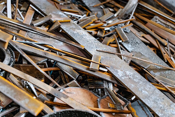 Metal waste after processing and cutting metal at the factory in the workshop. Scrap metal. Recycling of metal waste.