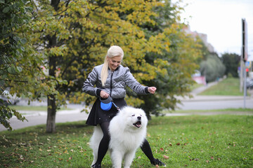 Lovely girl on a walk with a beautiful dog