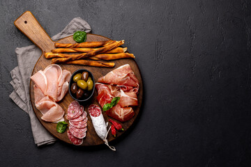 Antipasto board with various meat and snacks