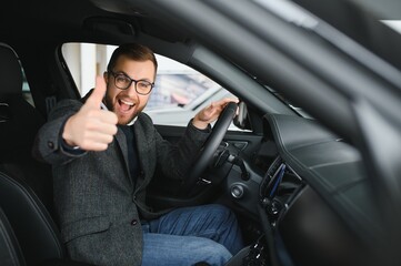 His true love. Portrait of a mature man smiling happily sitting in a brand new car - obrazy, fototapety, plakaty