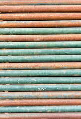 Close up stack of rusty metal pipes