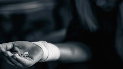 Woman with bunch of pills in hand.