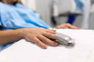 Closeup of hand with finger pulse oximeter. Using finger pulse oximeter, monitoring vital sign,...