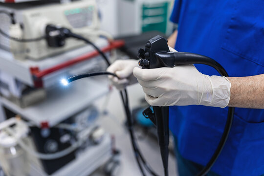 Doctor proctologist holding endoscope during colonoscopy. Probe colonoscope. Doctor gastroenterologist with probe to perform gastroscopy and colonoscopy