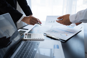 Business team analyzing income charts and graphs with laptop computers. business analysis Brainstorm ideas, strategies, discuss charts and graphs showing the results of successful teamwork.