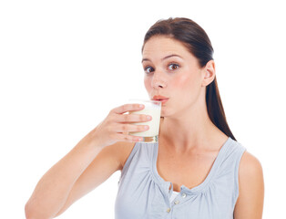 Drink up. Portrait, studio and woman drinks glass of milk for healthcare benefits, bone health or wellness hydration. Calcium dairy product, nutritionist face and model isolated on white background.