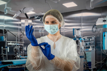 Fototapeta na wymiar nurse wears uniform with while putting rubber latex gloves during complex surgical operation.