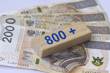 Inscription 800 plus next to 200 Polish zloty banknotes. 800 plus is evaluation of the 500 plus program in Poland, state program in the field of social policy.