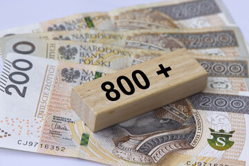 Inscription 800 plus next to 200 Polish zloty banknotes. 800 plus is evaluation of the 500 plus program in Poland, state program in the field of social policy. - obrazy, fototapety, plakaty