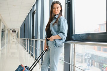 Cheerful attractive young woman travelling by world.