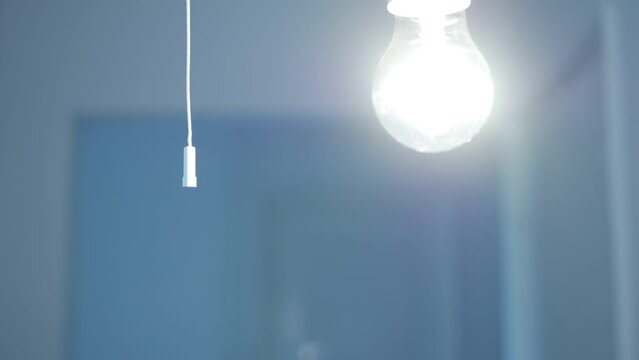 Girl Turns the Light On at Home, Pull Switch On Off, Turning the Light On a Led Bulb, Turn On the Light in a Dark Room