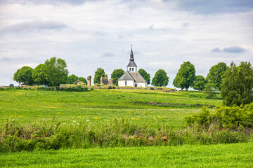 Fototapeta na wymiar View at a church in a rural landscape in the summer