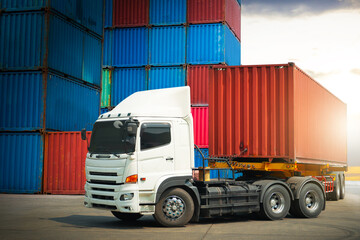 Semi trailer Trucks Parked with Stacked of Containers Cargo Shipping. Handling of Logistics Transportation Industry. Cargo Container ships, Freight Trucks Import-Export. Distribution Warehouse.