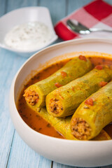 Recipe of stuffed courgette with tomato sauce, Lebanese style, Kouca Mehchi bi Banadoura, with Greek yogurt. High quality photo