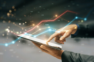 Close up of businessman hand using cellphone with glowing business chart lines with bokeh sparkles on blurry background. Annual report, finance and success concept. Double exposure.