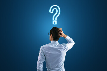 Back view to a thoughtful businessman and a question mark on his head on a dark blue background, search for a solution and doubt concept - obrazy, fototapety, plakaty