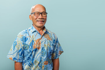 Portrait of Cheerful Asian Chinese senior man wearing casual T-shirt and eyeglasses looking at...