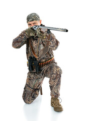 Full length portrait of duck hunter with a rifle and binoculars aiming a gun isolated on white background. Fifty-year-old man in hunting uniform posing in studio.