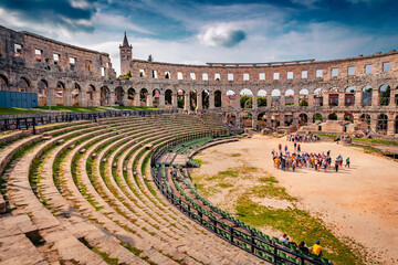 A lots of tourists on popular touris destination - Pula Arena, Huge Roman amphitheater with an underground exhibition about ancient olive oil and wine production, Croatia, Europe.