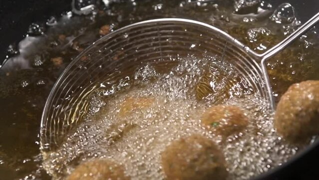 Ramadan Delights, Hummus Falafel, Middle Eastern Culture. Falafel balls frying, Open Fire Cooking, Deep fried street food, High quality 4k footage
