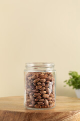 Raw pink beans in a glass jar. Vegetable protein. Healthy eating.