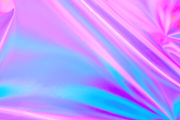 Blurred ethereal pastel neon pink, purple, mint blue holographic metallic foil background texture. Abstract futuristic disco, rave, festive dreamlike backdrop, Lo-fi multicolor vintage retro design