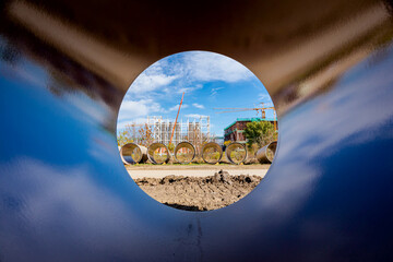 Look through stone pipes with resistant glaze placed on the ground in front construction site