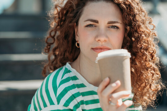 Woman With Curly Hair Holding Disposable Coffee Cup