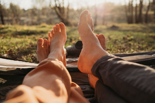 Couple spending leisure time in tent on sunny day