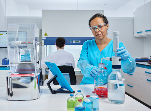 Scientist preparing chemical at desk in microbiological laboratory