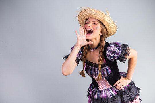 Blonde Brazilian woman, June party clothes, arraial. shouting promotion.