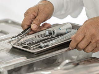 Dentist working with dental tools in dental clinic, closeup