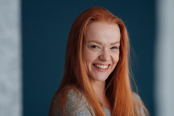 Portrait of cheerful redhead woman