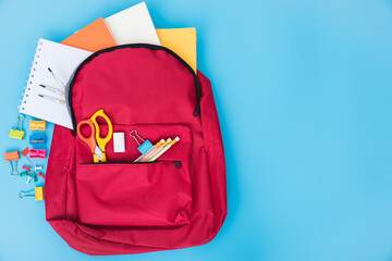 Top view flat lay of red school bag backpack and accessories tools for children education on blue background, Back to school concept and have copy space for use