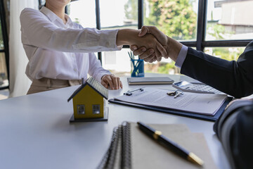 Successful handshake and agreement Real estate agent and client celebrating contracts completed after signing on home insurance and investment loans. house sale ideas