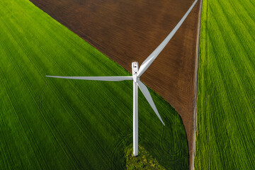 Aerial view of wind turbine on agricultural field
